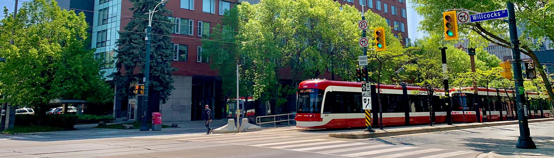 510 streetcar on Spadina with New College in the background.